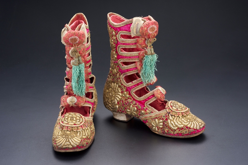 Woman’s ankle boots. Java, late 19th century. Silk, lametta, metal, sequins, gold, brass, stucco, height 24.5 cm. Peranakan Museum, Gift of Mr and Mrs Lee Kip Lee